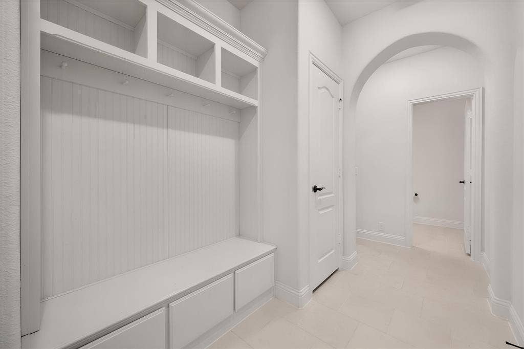 5626 Rutherford Drive, Midlothian, TX 76065 This built-in mudroom bench is such a smart feature — cubbies up top, a bench to sit on, drawers below. This is where backpacks and shoes go to live, keeping the rest of the house tidy.