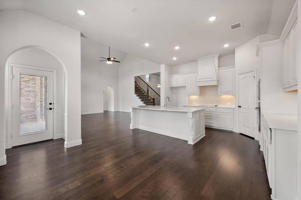 5626 Rutherford Drive, Midlothian, TX 76065 One more look at that beautiful kitchen from a different angle — you can really appreciate how the cabinetry wraps around and how much natural light comes through.