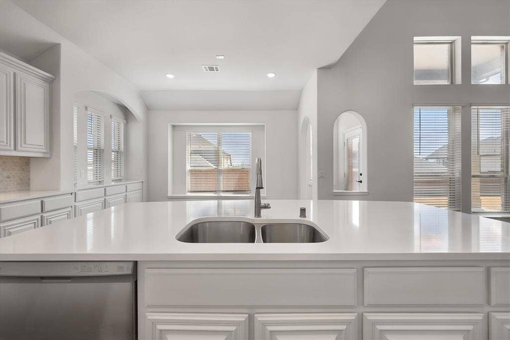 5626 Rutherford Drive, Midlothian, TX 76065 And here's the view from the sink — double basin, gorgeous quartz countertops, and windows right in front so you're never doing dishes without a view.