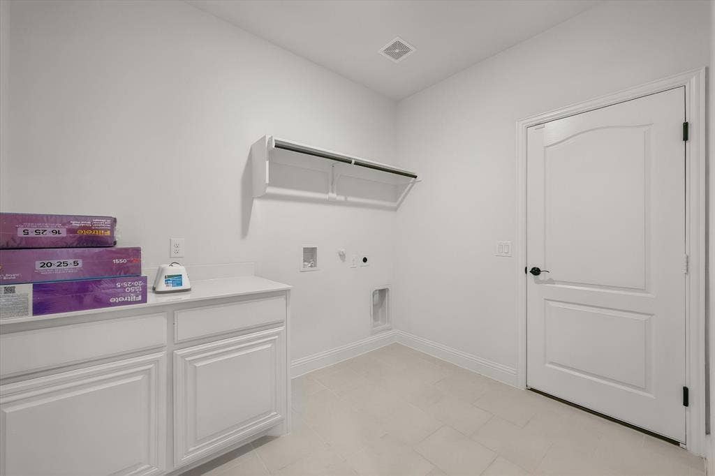 5626 Rutherford Drive, Midlothian, TX 76065 And right around the corner, your laundry room — plenty of counter space up top for folding, and cabinets for storage.