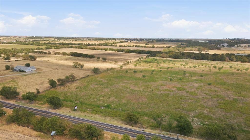 TBD N Louisiana Drive, Celina, TX 75009 Expansive rural landscape featuring scattered trees, open fields, and a distant residential structure