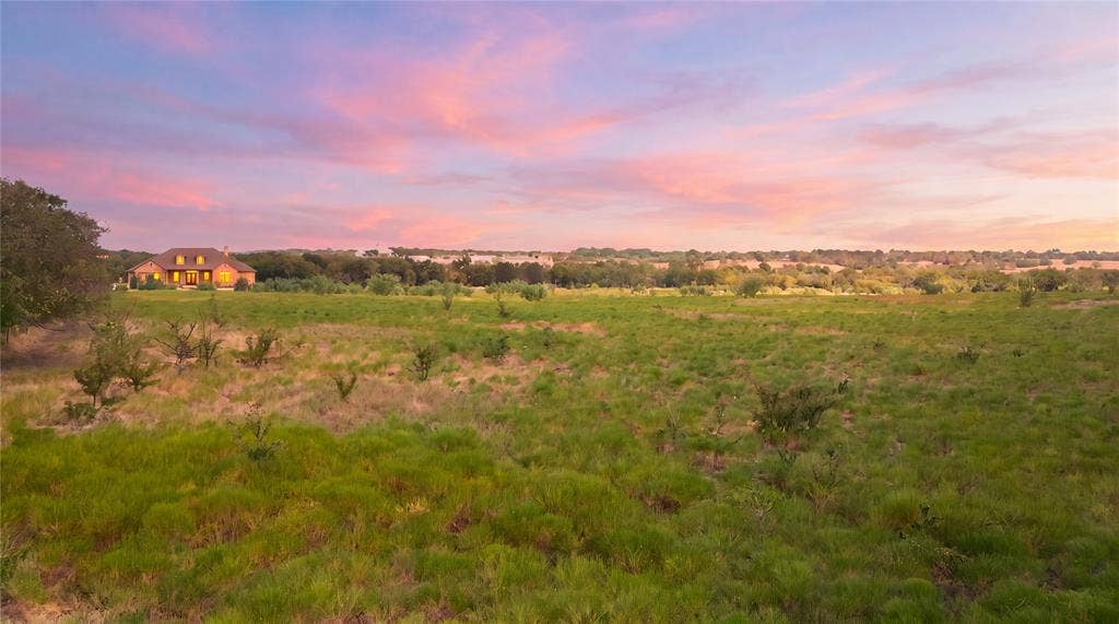 TBD N Louisiana Drive, Celina, TX 75009 Expansive grassy landscape with distant residential structures