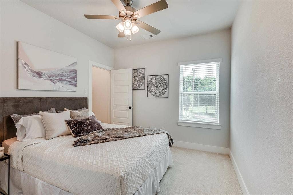 505 Mission Trail, #603, Arlington, TX 76010 Bedroom featuring a ceiling fan with integrated lighting, carpeted flooring, and a window with blinds