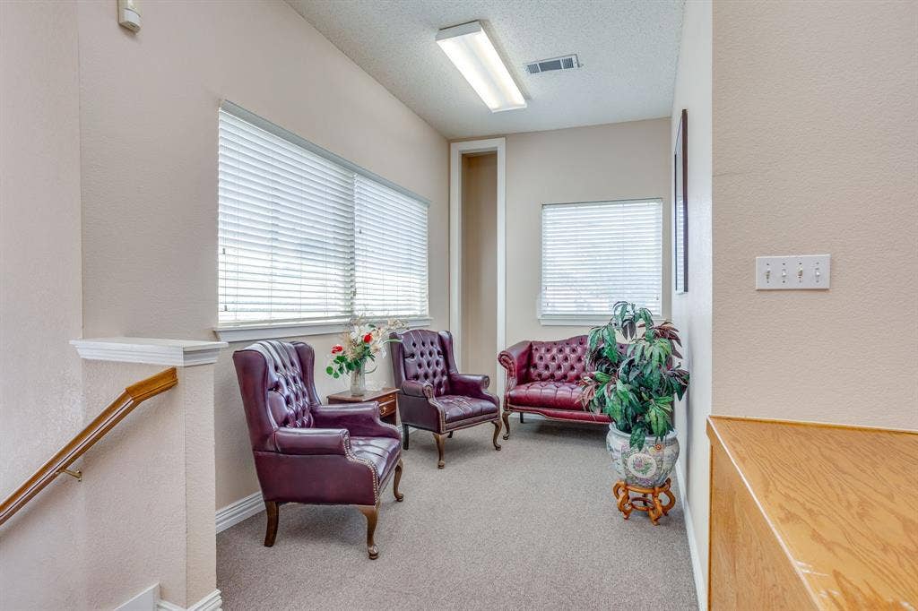 1415 E Belt Line Road, Carrollton, TX 75006 Carpeted area with multiple windows featuring horizontal blinds