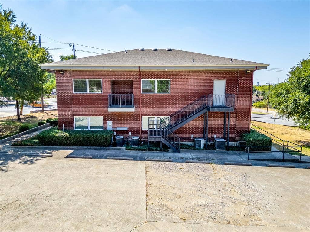 1415 E Belt Line Road, Carrollton, TX 75006 Brick exterior featuring multiple windows and a balcony