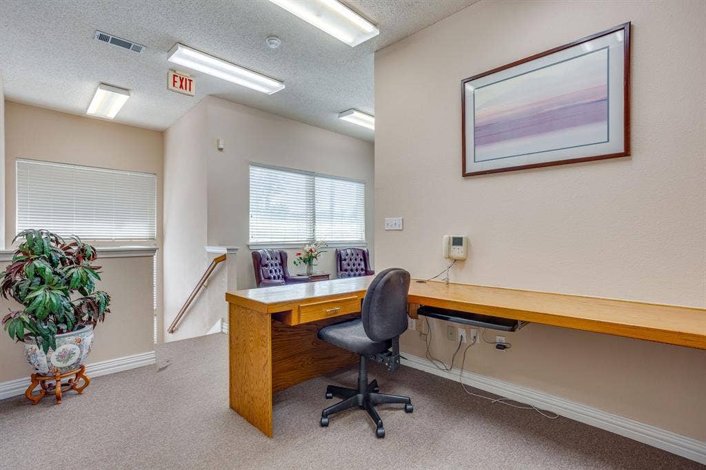 1415 E Belt Line Road, Carrollton, TX 75006 Carpeted office area featuring a built-in desk, wood-finish desktop, and multiple windows with blinds