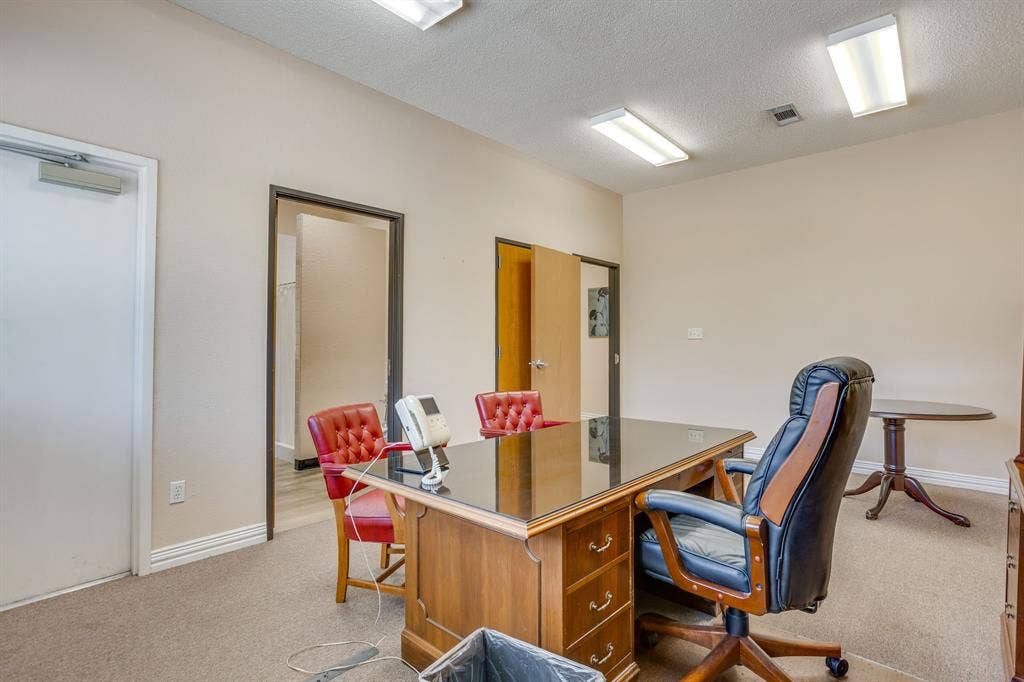 1415 E Belt Line Road, Carrollton, TX 75006 Neutral wall paint, ceiling-mounted fluorescent lighting, and two interior doorways
