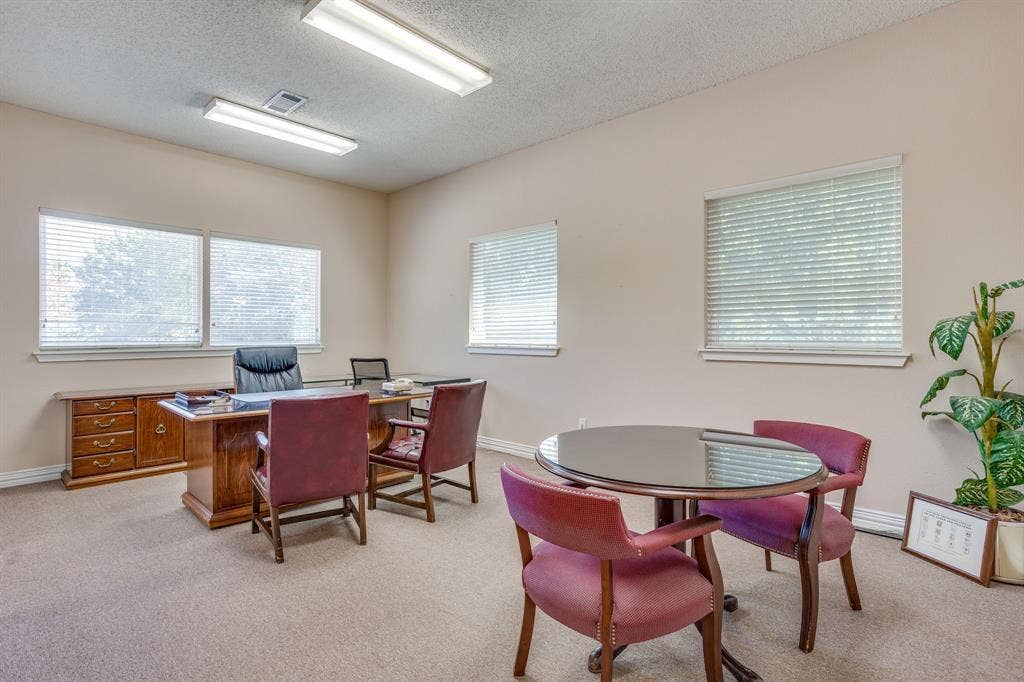 1415 E Belt Line Road, Carrollton, TX 75006 Neutral wall paint, carpeted flooring, multiple windows with blinds, and overhead fluorescent lighting