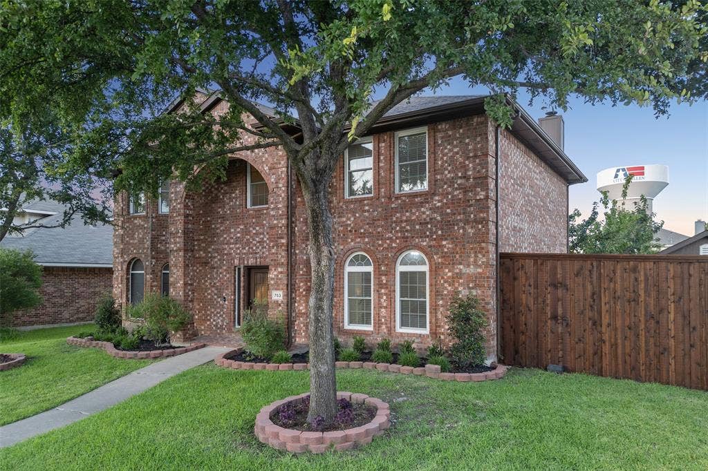 753 Summerfield Drive, Allen, TX 75002 Brick exterior with arched entry, arched windows, and a wood privacy fence