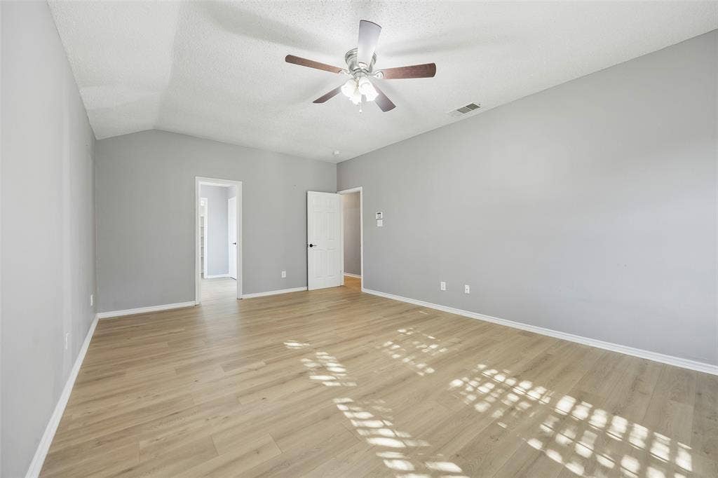 753 Summerfield Drive, Allen, TX 75002 Spacious room featuring vaulted ceilings, wood-finish flooring, and a ceiling fan