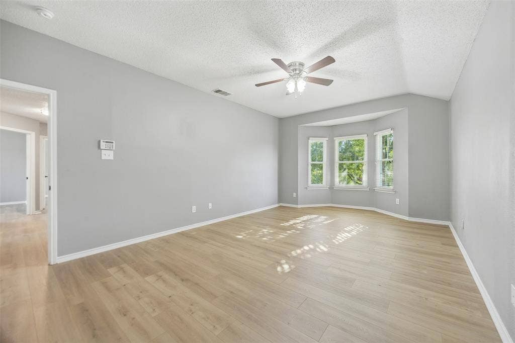753 Summerfield Drive, Allen, TX 75002 Expansive room featuring wood-finish flooring, a ceiling fan with integrated lighting, and a bay window ensemble