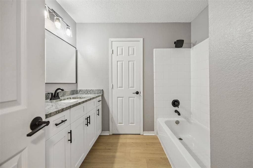 753 Summerfield Drive, Allen, TX 75002 White vanity with dark hardware, granite-style countertop, and rectangular sink