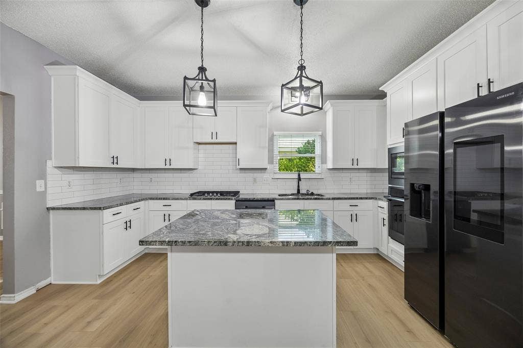 753 Summerfield Drive, Allen, TX 75002 Kitchen featuring white shaker cabinetry, dark stone countertops, stainless steel appliances, and wood-finish flooring