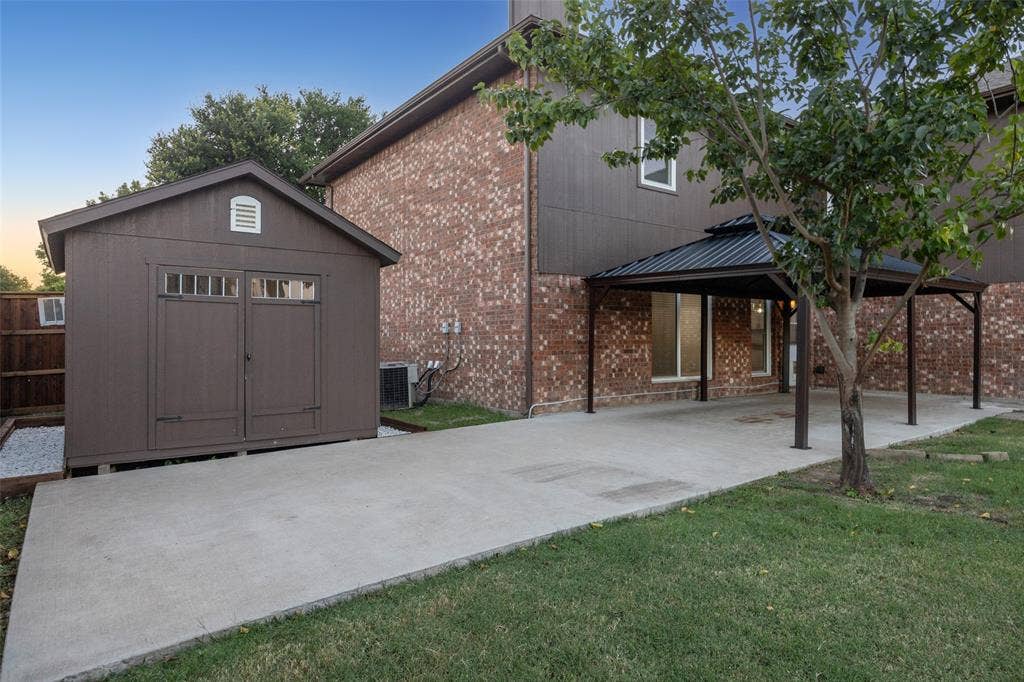 753 Summerfield Drive, Allen, TX 75002 Brick exterior, covered patio, concrete pathway, detached storage shed, privacy fence