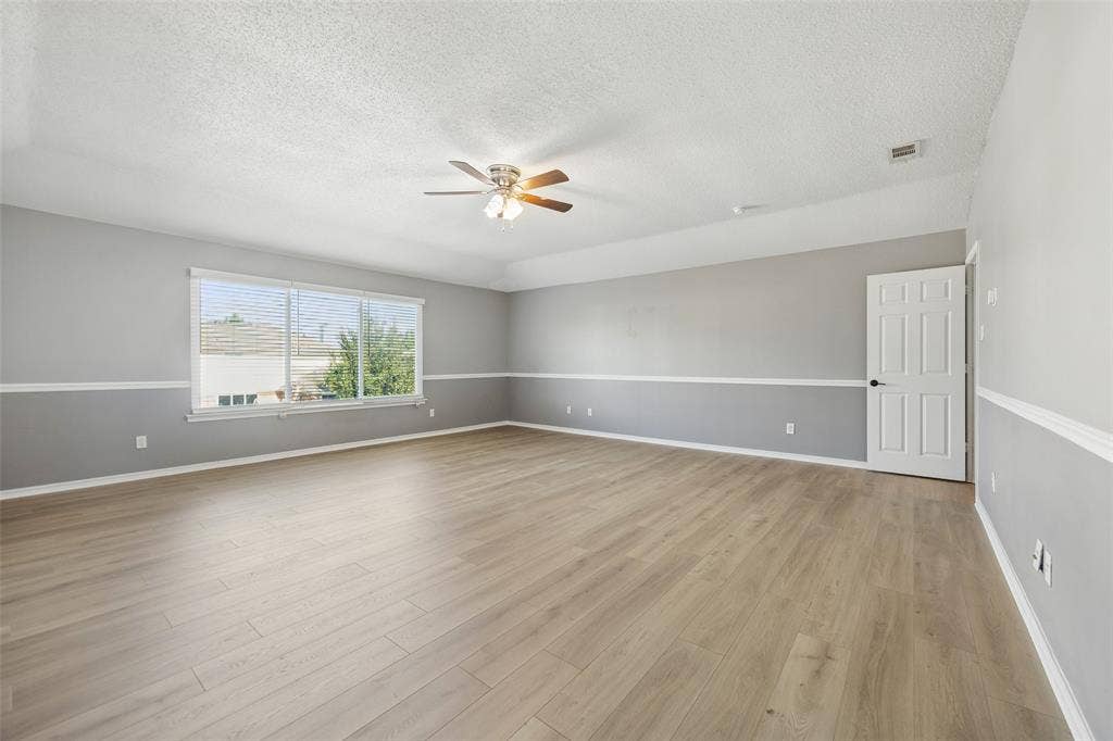 753 Summerfield Drive, Allen, TX 75002 Expansive room featuring wood-finish flooring, a ceiling fan, and a large window with horizontal blinds