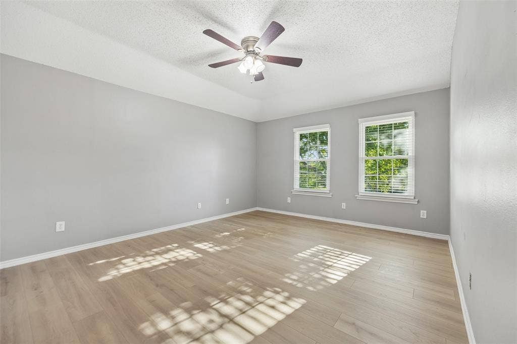 753 Summerfield Drive, Allen, TX 75002 Spacious room featuring wood-finish flooring, light gray walls, two windows with blinds, and a ceiling fan
