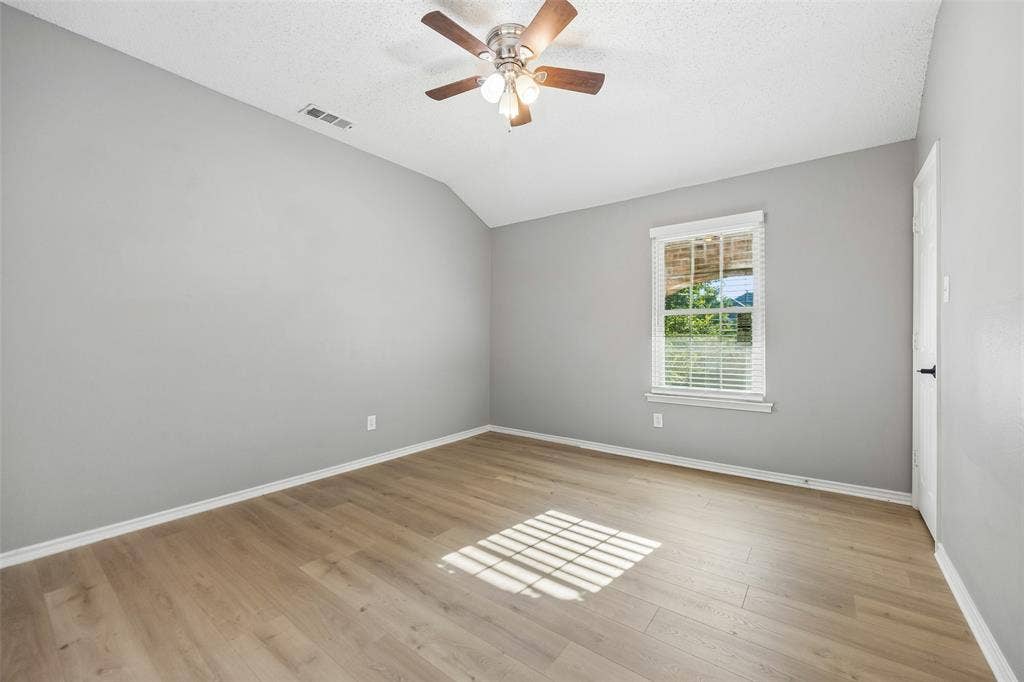 753 Summerfield Drive, Allen, TX 75002 Vaulted ceiling with a ceiling fan, light wood-finish flooring, and a window with blinds