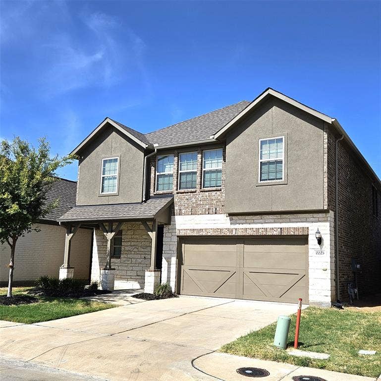 2225 Crooked Bow Drive, Mesquite, TX 75149 Two-story residence featuring a mixed-material facade with stone, brick, and stucco