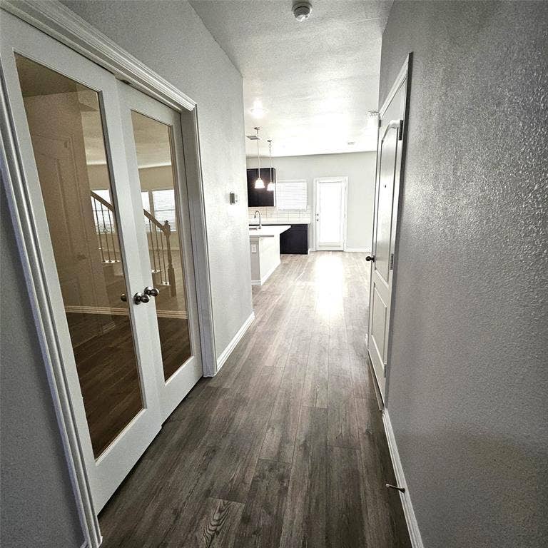 2225 Crooked Bow Drive, Mesquite, TX 75149 Wood-finish flooring throughout, white trim, and a light gray wall finish