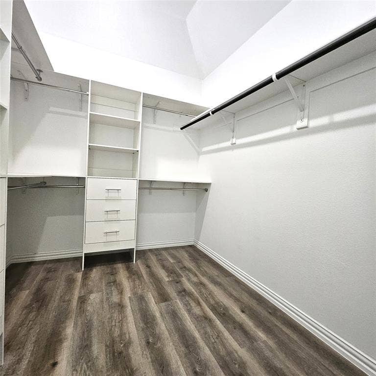 2225 Crooked Bow Drive, Mesquite, TX 75149 Wood-finish flooring, white built-in shelving, multiple hanging rods, three built-in drawers, and white walls