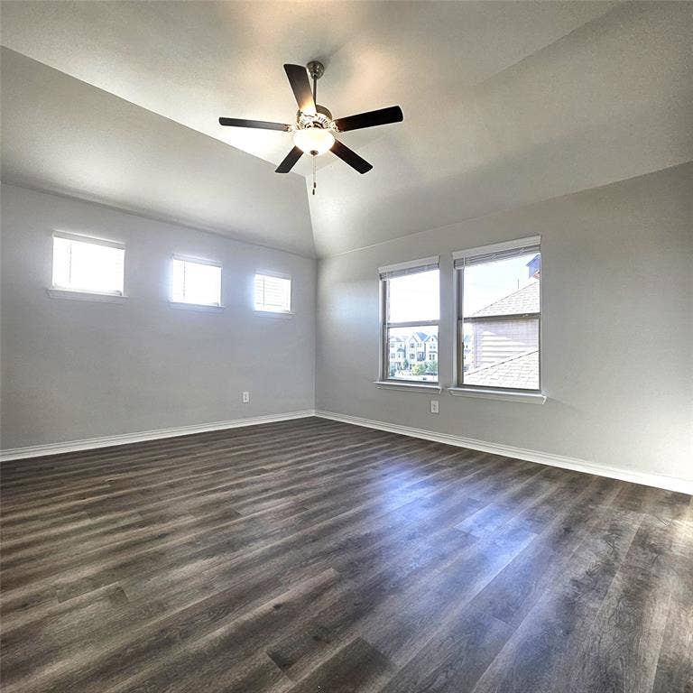 2225 Crooked Bow Drive, Mesquite, TX 75149 Vaulted ceiling with a ceiling fan, wood-finish flooring, and multiple windows