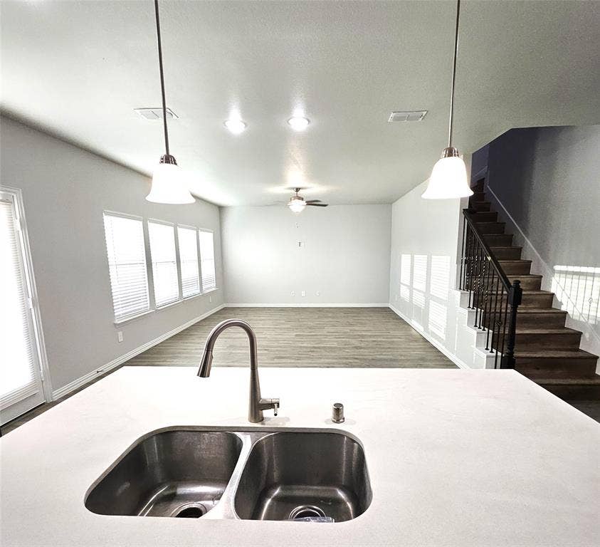 2225 Crooked Bow Drive, Mesquite, TX 75149 Kitchen island with a double basin stainless steel sink and gooseneck faucet