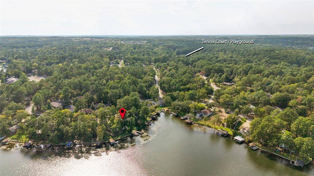 1551 E Tanglewood, Hideaway, TX 75771 Waterfront property with extensive tree coverage and surrounding residential structures
