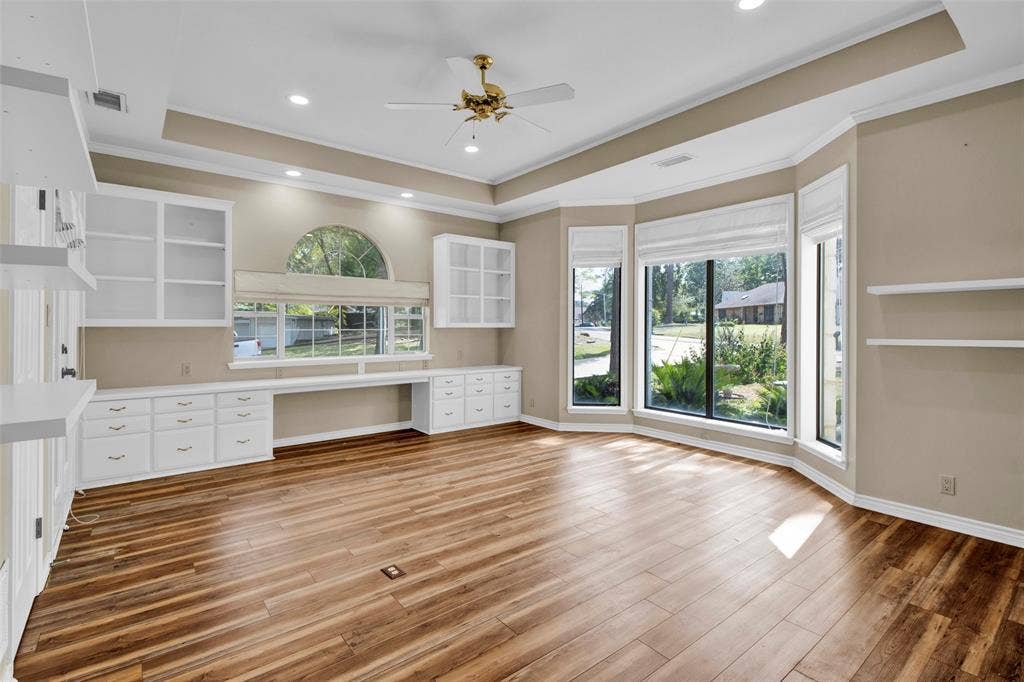 1551 E Tanglewood, Hideaway, TX 75771 Wood-finish flooring, extensive built-in cabinetry with shelving, recessed lighting, ceiling fan, and bay windows