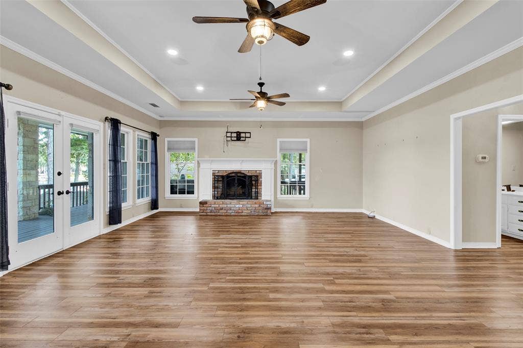 1551 E Tanglewood, Hideaway, TX 75771 Wood-finish flooring, recessed lighting, and a tray ceiling