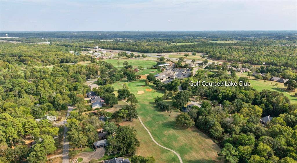 1551 E Tanglewood, Hideaway, TX 75771 Aerial perspective of a golf course community with extensive tree coverage