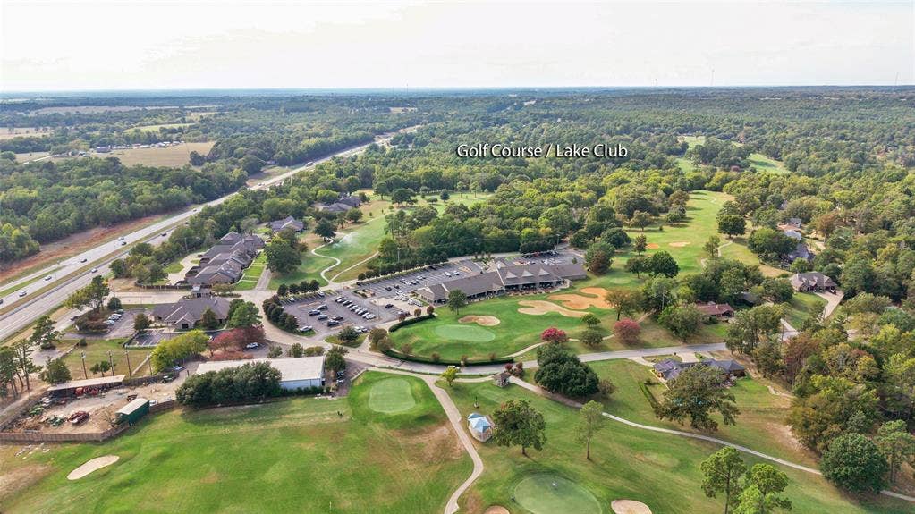 1551 E Tanglewood, Hideaway, TX 75771 Expansive aerial perspective featuring a golf course, surrounding wooded areas, and a multi-lane highway