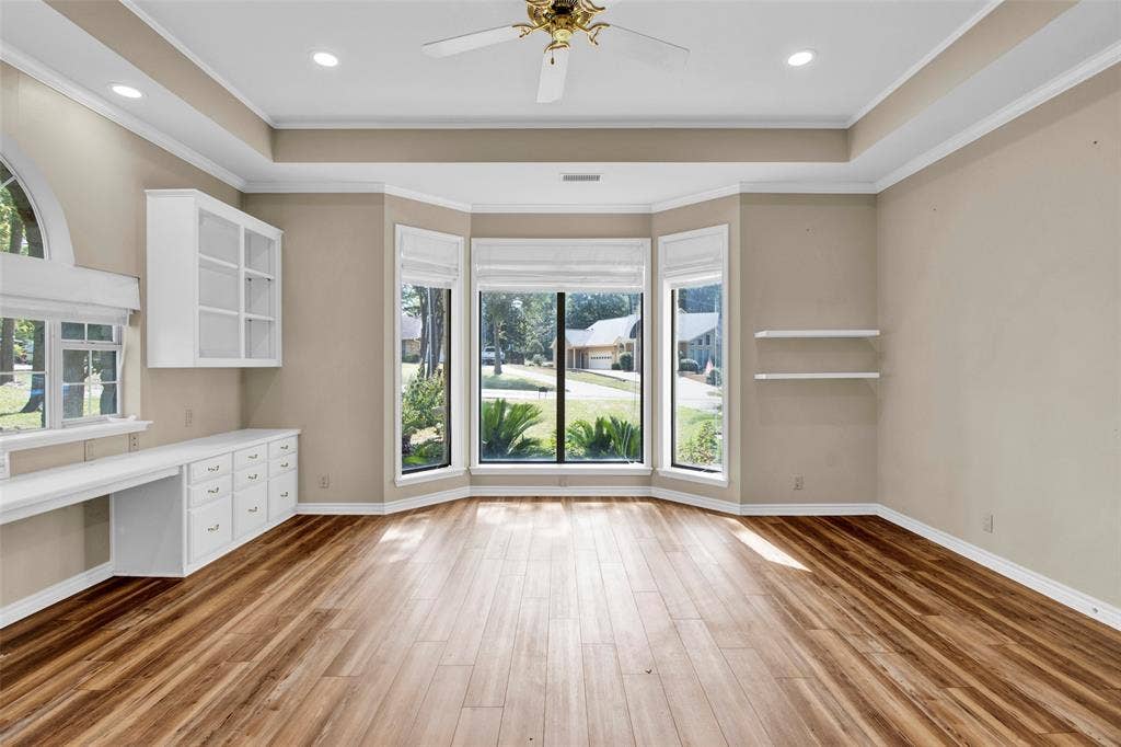 1551 E Tanglewood, Hideaway, TX 75771 Wood-finish flooring, built-in cabinetry, recessed lighting, ceiling fan, and a large bay window