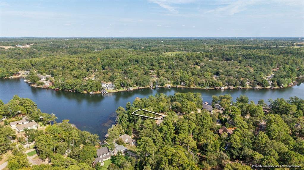1551 E Tanglewood, Hideaway, TX 75771 Waterfront property with mature trees and a defined lot boundary