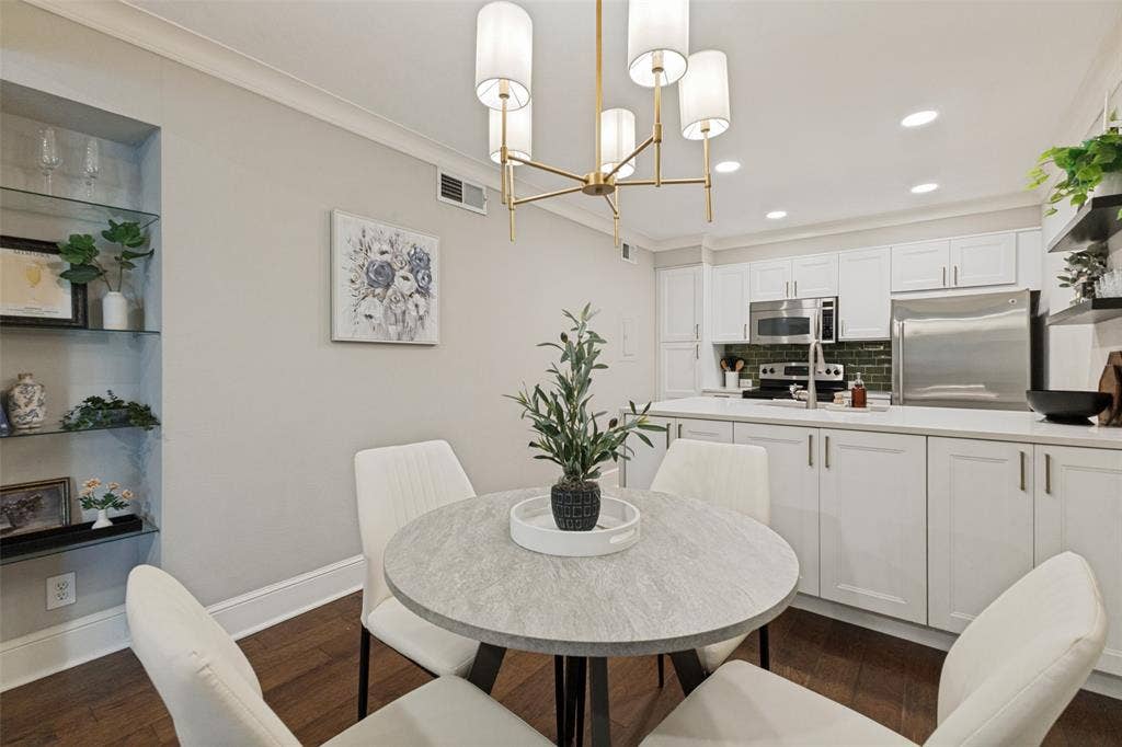 5934 Sandhurst Lane, #208, Dallas, TX 75206 Kitchen featuring white cabinetry, stainless steel appliances, dark green subway tile backsplash, and light countertops