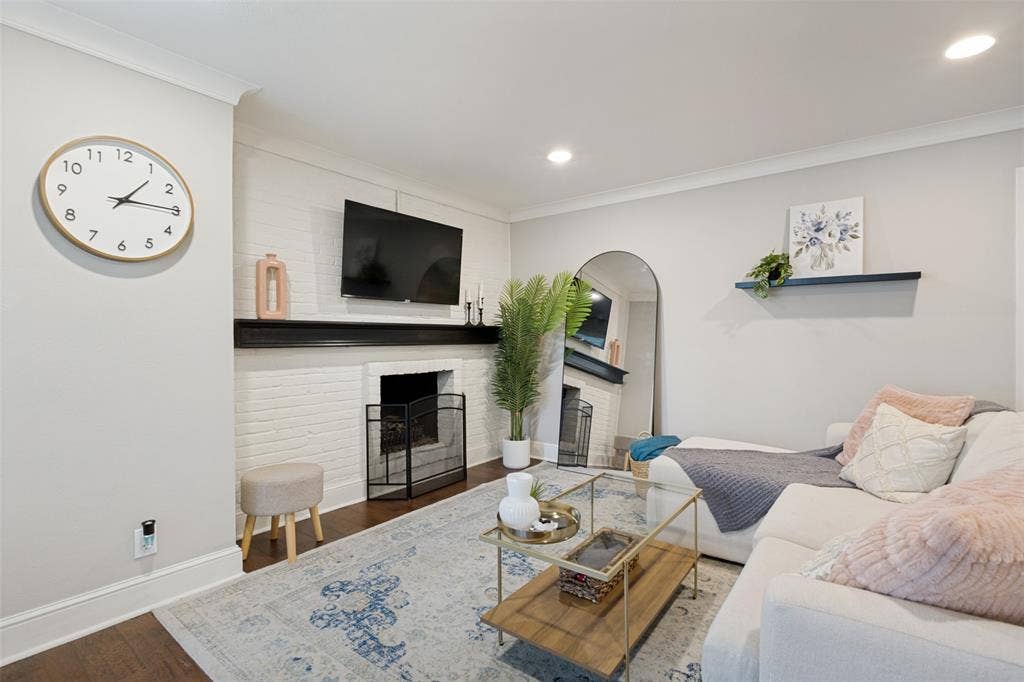 5934 Sandhurst Lane, #208, Dallas, TX 75206 Painted brick fireplace with a dark wood mantel
