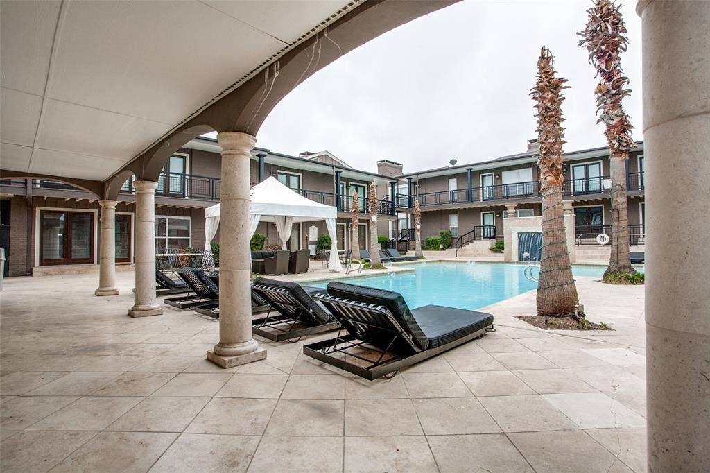 5934 Sandhurst Lane, #208, Dallas, TX 75206 Expansive pool deck with tiled surfacing, arched covered patio, and column supports