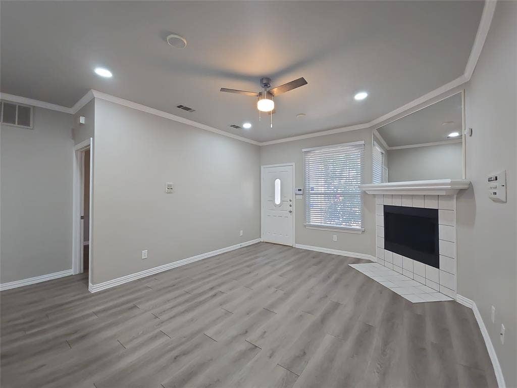 1501 Cedar Elm Drive, #102, Euless, TX 76039 Light wood-finish flooring, recessed lighting, and a ceiling fan create an inviting atmosphere