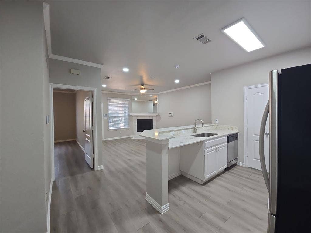1501 Cedar Elm Drive, #102, Euless, TX 76039 Kitchen island with undermount sink and stone countertop