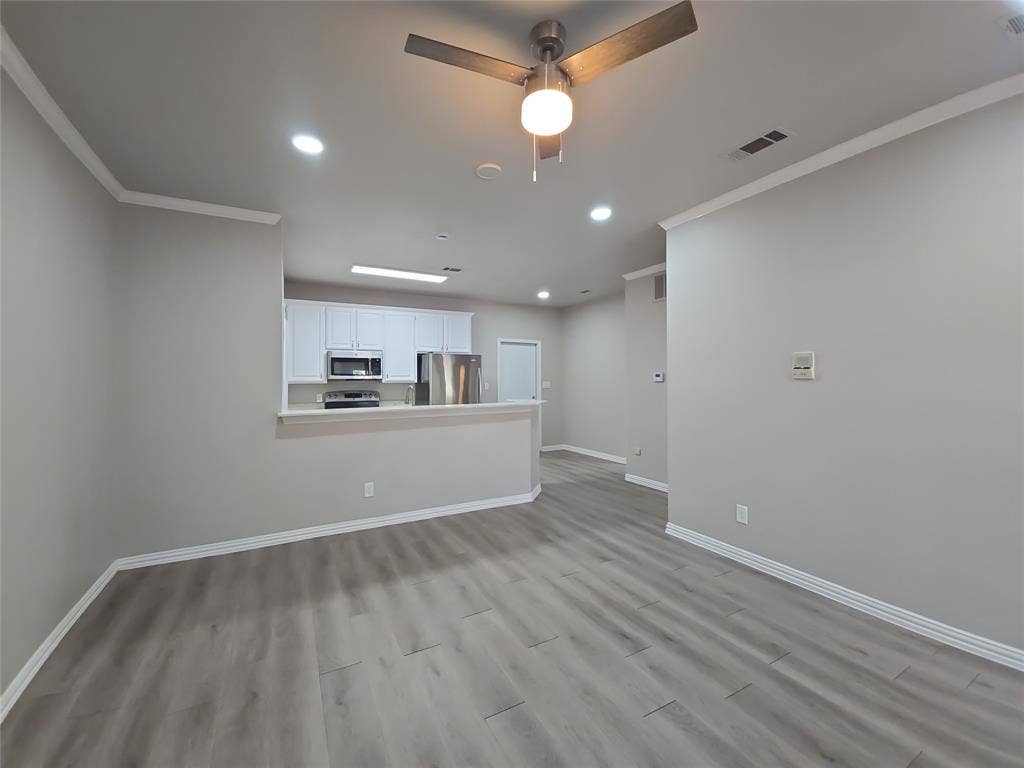1501 Cedar Elm Drive, #102, Euless, TX 76039 Wood-finish flooring throughout, complemented by white trim and crown molding