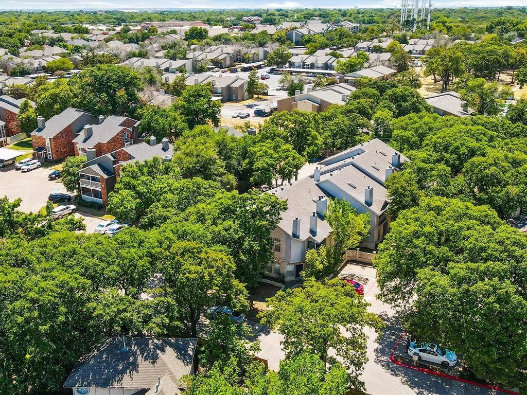 1501 Cedar Elm Drive, #102, Euless, TX 76039 Expansive property featuring mature trees, multiple buildings, and surface parking areas