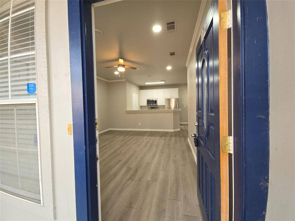 1501 Cedar Elm Drive, #102, Euless, TX 76039 Entryway opening to an open-concept living area with wood-finish flooring, recessed lighting, and a ceiling fan