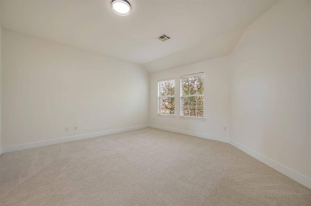 7904 Blacktail Trail, McKinney, TX 75070 Neutral tone wall paint, carpeted flooring, two windows with blinds, and an overhead flush-mount light fixture