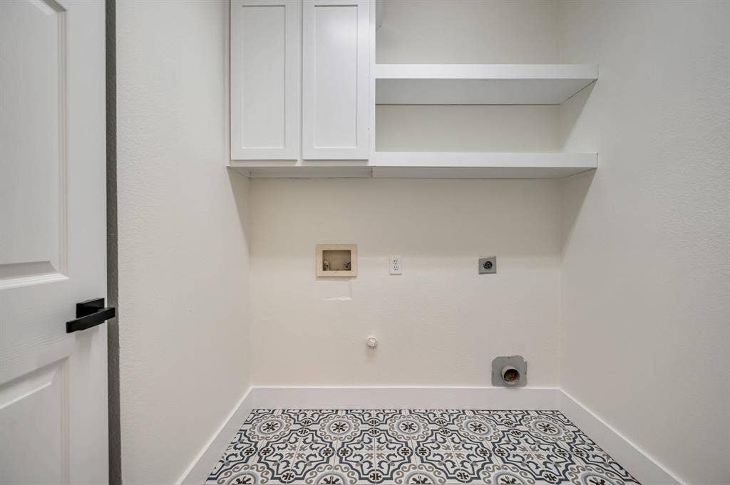 7904 Blacktail Trail, McKinney, TX 75070 White shaker-style cabinetry, open shelving, white walls, black door hardware, and patterned floor tiling