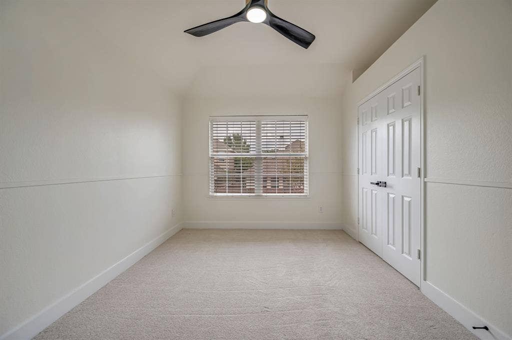 7904 Blacktail Trail, McKinney, TX 75070 Neutral tone carpet with window blinds, a modern ceiling fan, and a paneled closet door