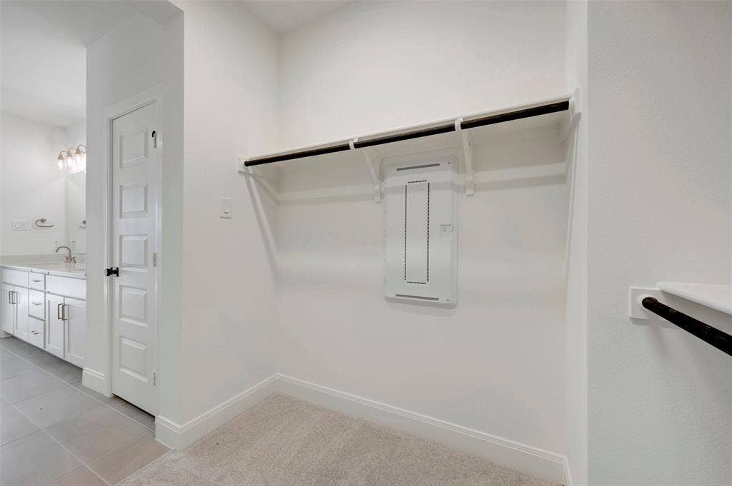 1616 Compass Heights, Mesquite, TX 75181 Built-in closet shelving and hanging rod with light-toned carpeting