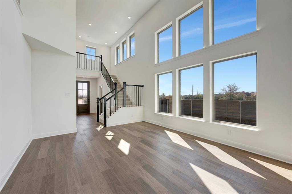 1616 Compass Heights, Mesquite, TX 75181 Vaulted ceiling, recessed lighting, wood-finish flooring, multi-pane windows, and a staircase with open balusters