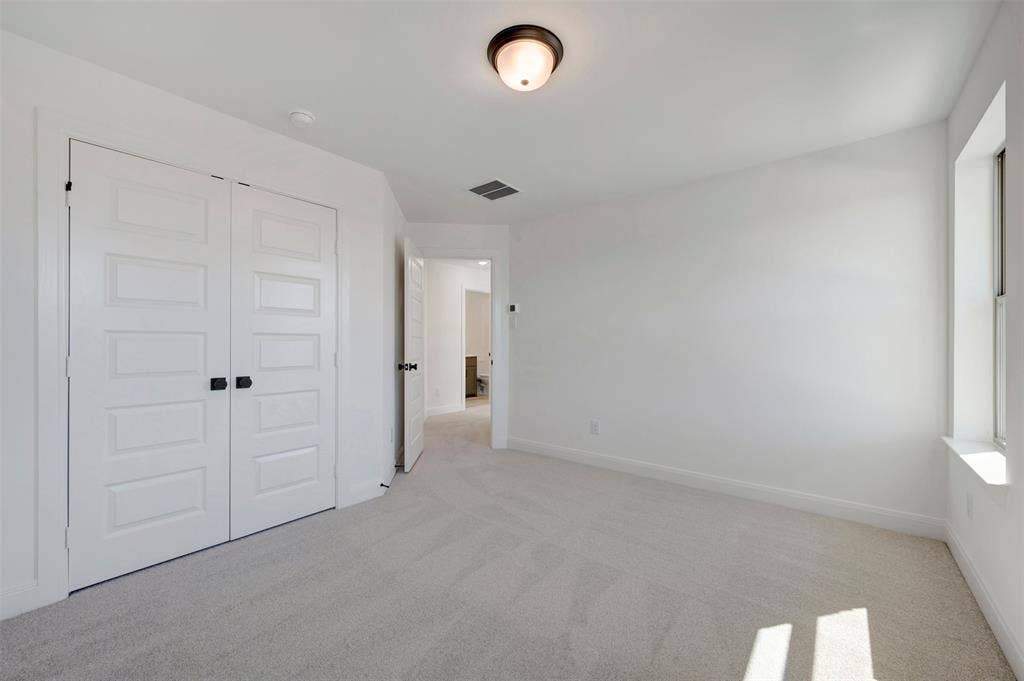 1616 Compass Heights, Mesquite, TX 75181 Carpeted flooring, white walls, window with sill, flush mount light fixture, and paneled double doors with dark hardware