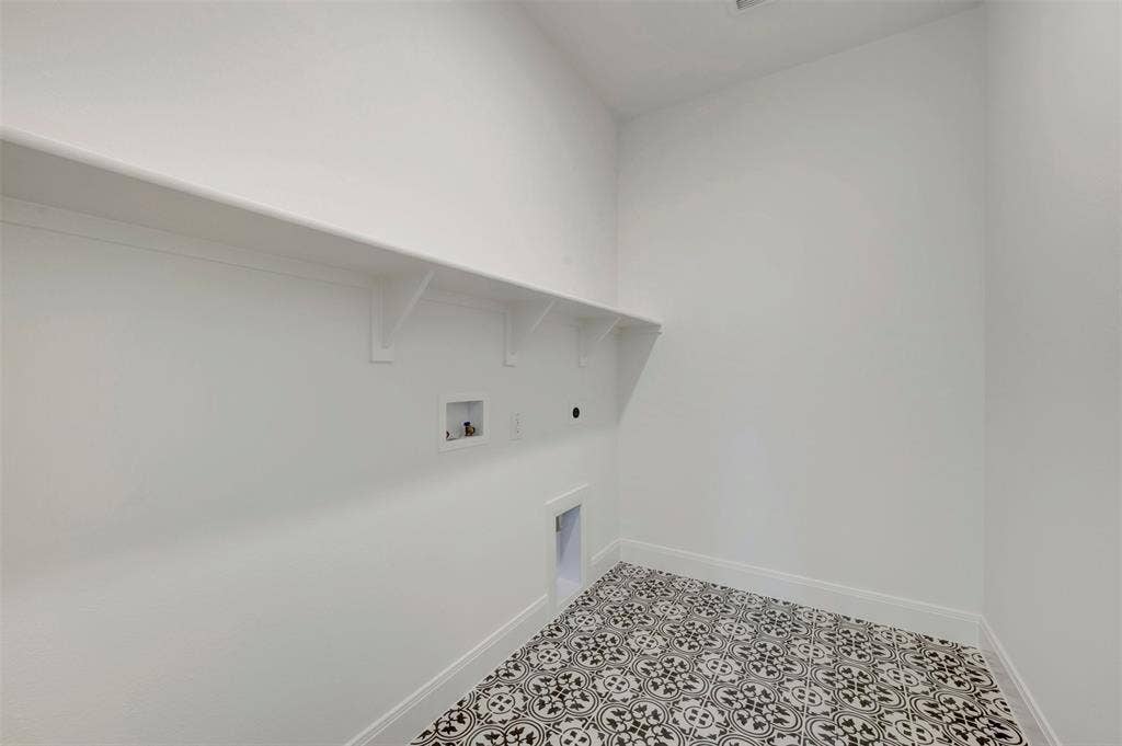 1616 Compass Heights, Mesquite, TX 75181 Laundry room featuring a white wall shelf, built-in utility connections, and patterned floor tile