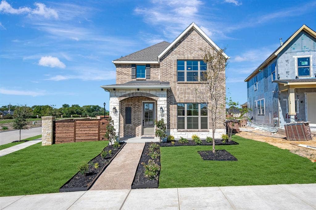 1616 Compass Heights, Mesquite, TX 75181 Brick facade, stone accents, arched entry, manicured landscaping, and a paved walkway