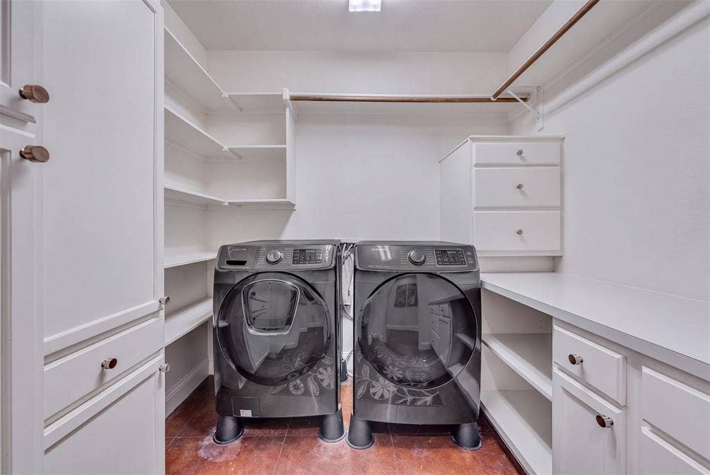 Laundry area featuring built-in cabinetry, shelving, and a hanging rod